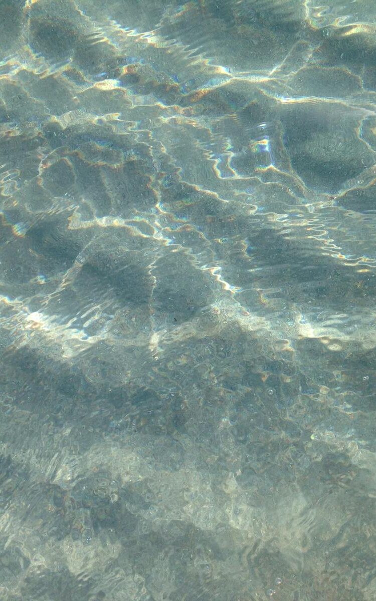 Crystal clear ocean water displaying peaceful ripples and reflections in Boca Raton, Florida.